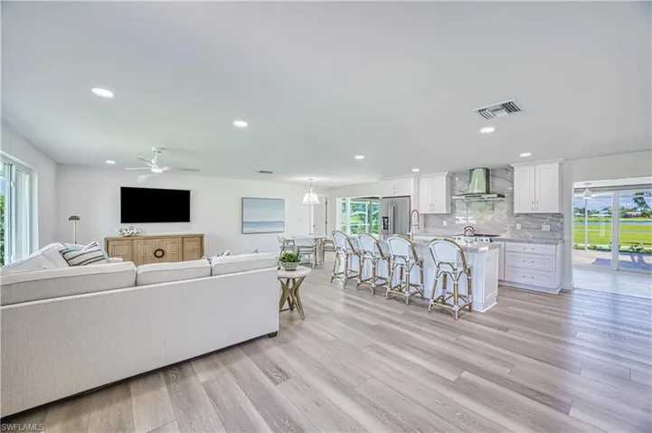 Living area featuring light wood finished floors, recessed lighting, and ceiling fan