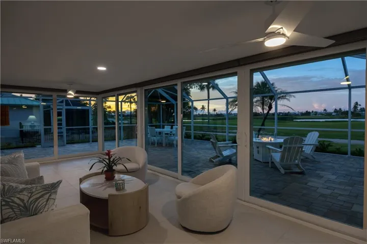 unroom / solarium featuring outdoor lounge area, and a patio area during sunset