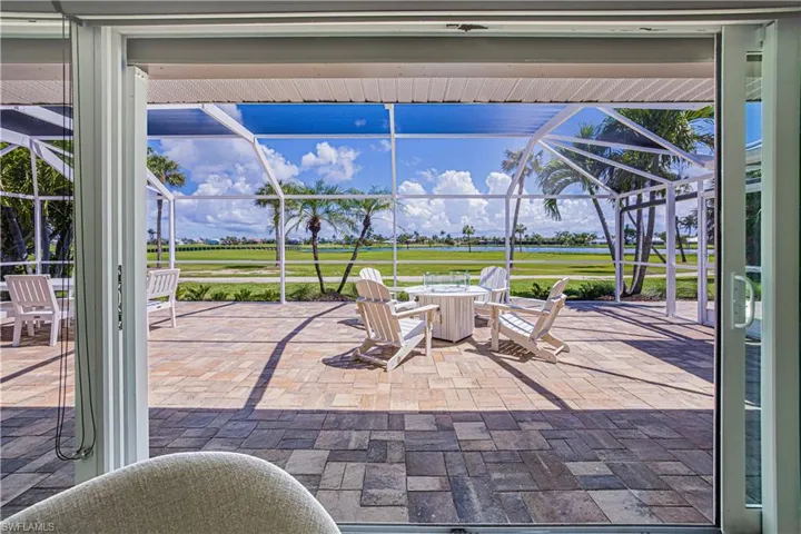 View of patio / terrace featuring a water view, a sunroom, and glass enclosure
