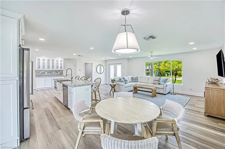 Dining room featuring light wood-style flooring, recessed lighting, and ceiling fan