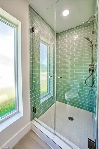 Full bathroom with a stall shower and wood finished floors