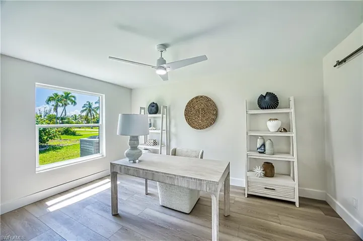 Bedroom furnished as office space featuring light wood finished floors and a ceiling fan