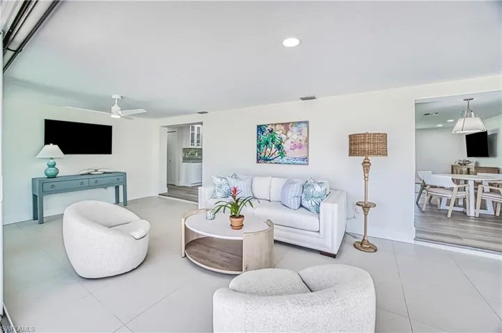 Living room featuring light tile patterned flooring, and recessed lighting
