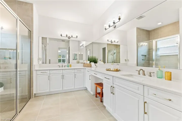 Master bath features ample storage, dual sinks, step in shower, and make up desk