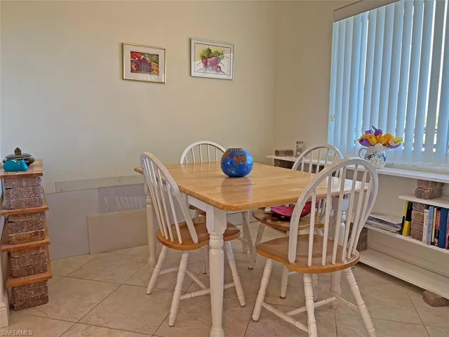 Dining space with light tile patterned floors