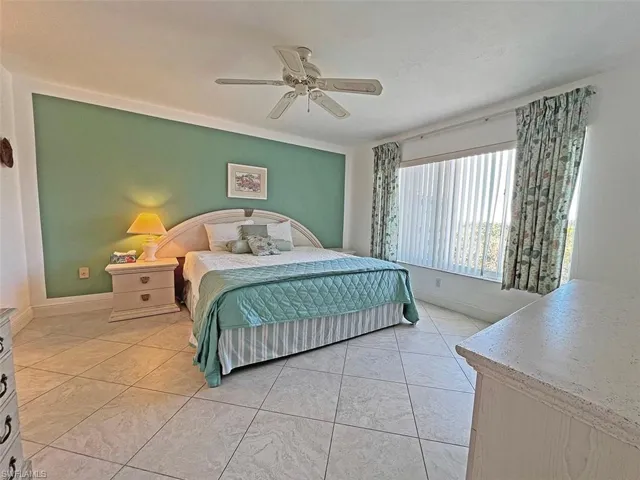 Bedroom featuring baseboards and ceiling fan