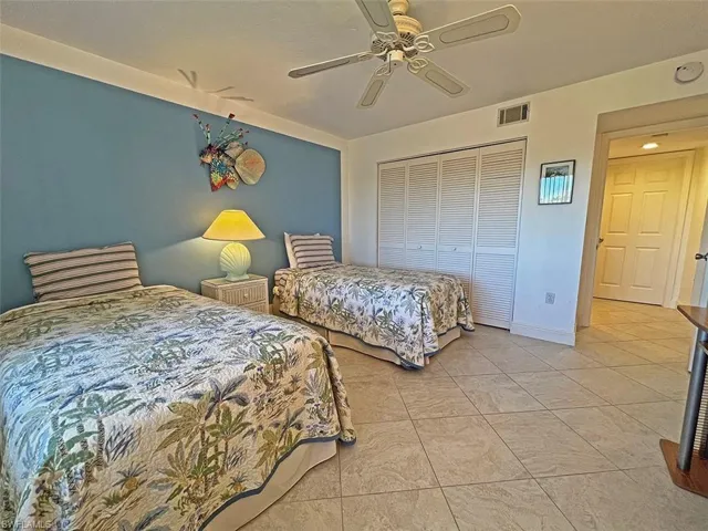 Bedroom featuring ceiling fan and a closet
