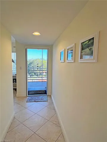 Doorway to outside with healthy amount of natural light and tile patterned floors