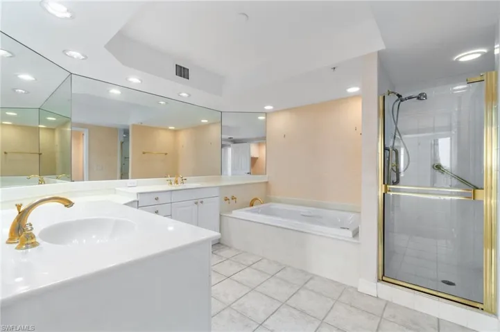 Bathroom featuring vanity, separate shower and tub, and tile patterned floors