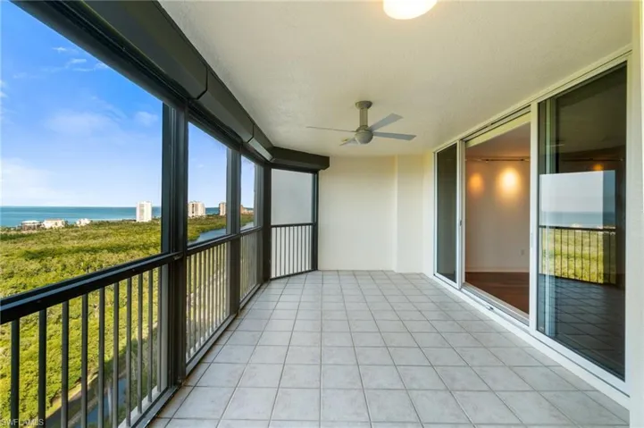 Unfurnished sunroom with a water view and ceiling fan