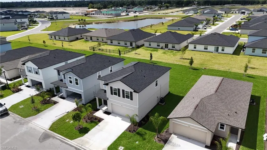 Contemporary residential street featuring multiple single-family homes with asphalt shingle roofs
