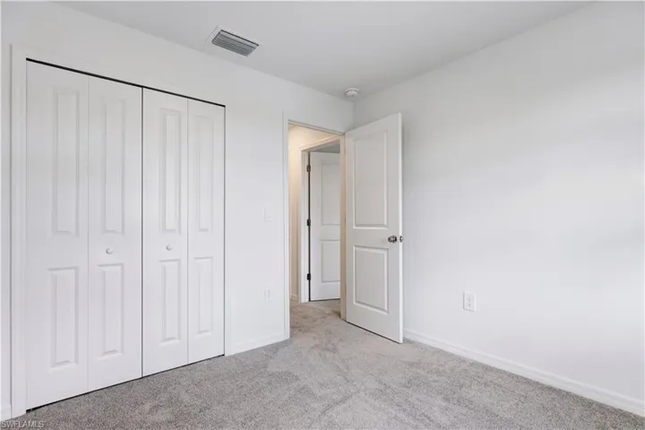 Room featuring light gray carpet flooring and white painted walls