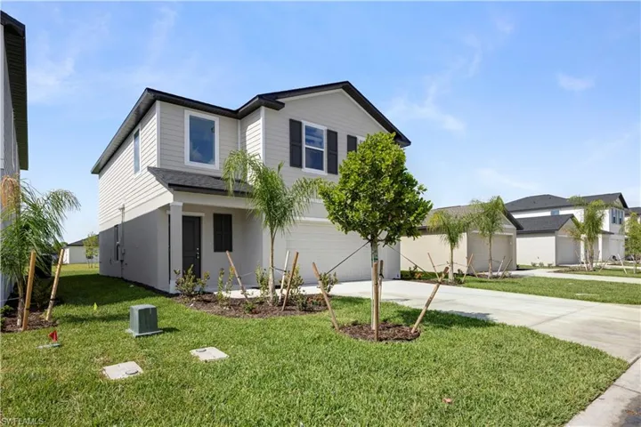 Two-story residence featuring light gray siding and dark gray shutters