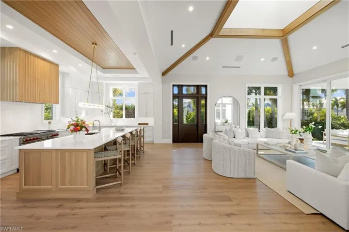Living area with light wood-style floors and recessed lighting