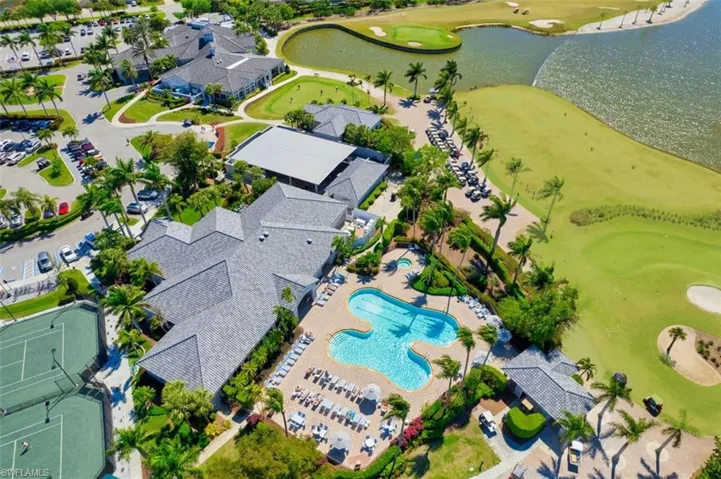 Aerial view of property and surrounding area with a golf club and a large body of water