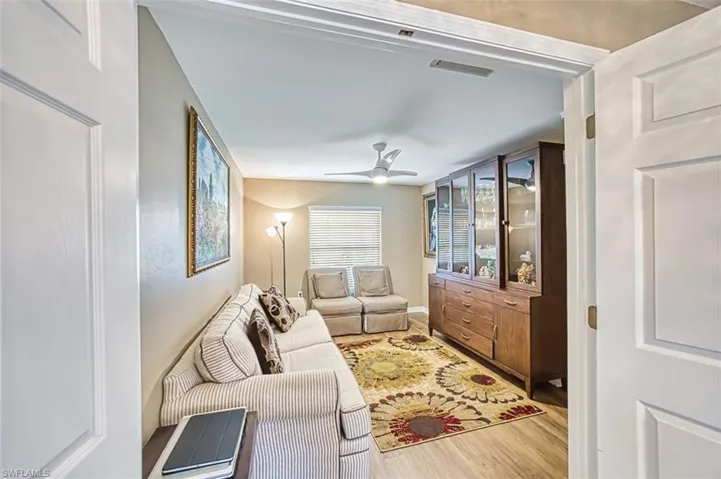 Living area with wood finished floors and ceiling fan