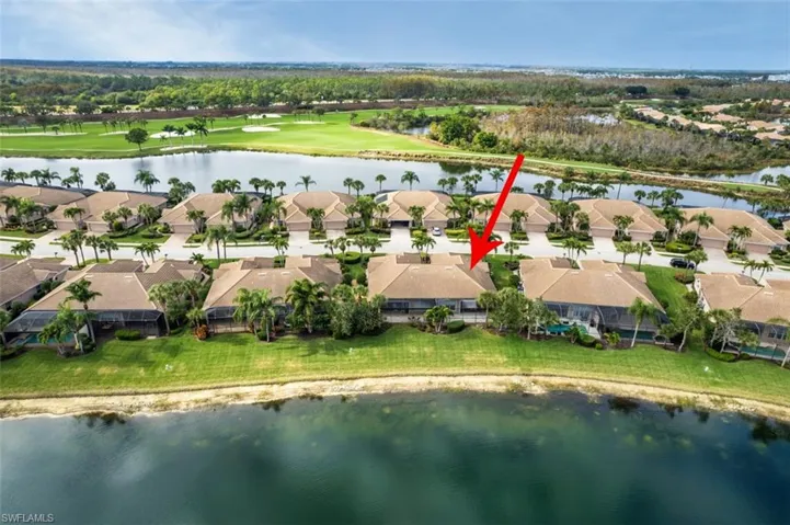 Aerial perspective of suburban area featuring a large body of water