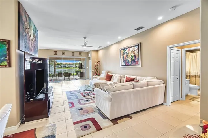 Living area with recessed lighting, ceiling fan, and light tile patterned floors