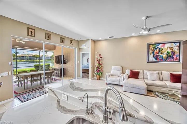 Living area featuring a ceiling fan, recessed lighting, and a sunroom
