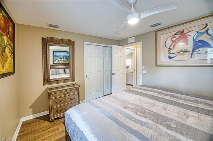 Bedroom featuring a closet, a ceiling fan, and wood finished floors
