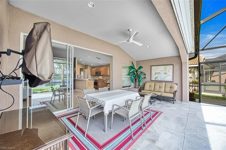 View of patio with glass enclosure, outdoor dining area, ceiling fan, a sunroom, and an outdoor living space