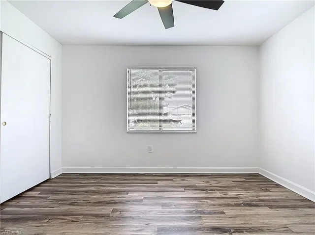 Unfurnished bedroom featuring wood finished floors, ceiling fan, and a closet