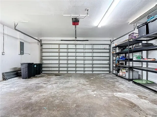 Garage with a garage door opener and electric panel