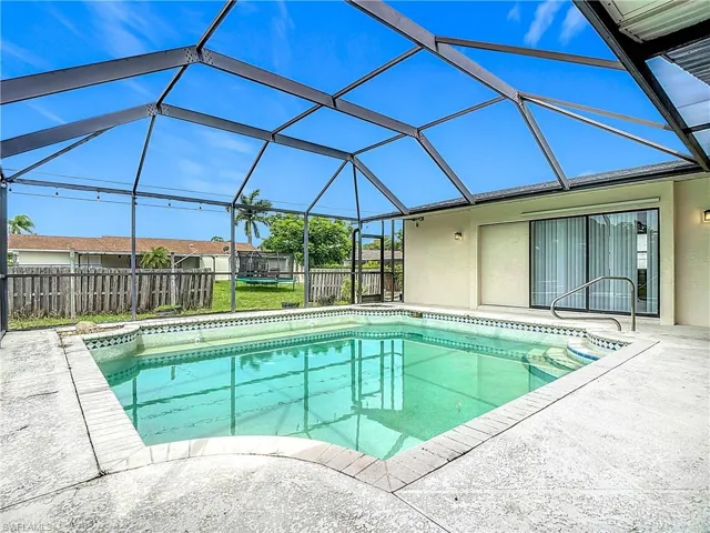 View of swimming pool with a patio, a fenced backyard, and a lanai