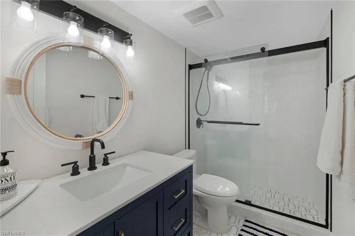 Full bathroom with a stall shower and vanity