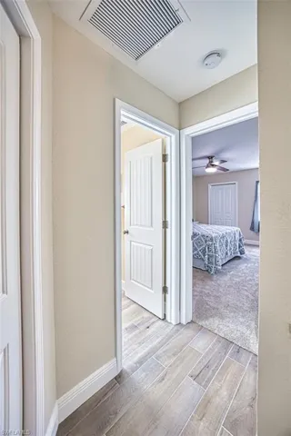 Hallway with wood finished floors and baseboards