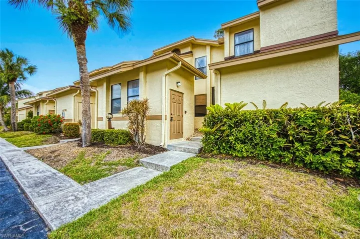 View of front of property with stucco siding and a front lawn