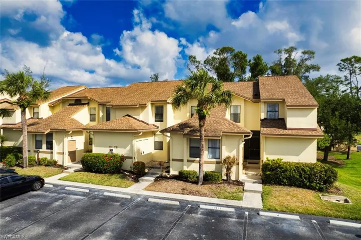 Multi unit property featuring uncovered parking and stucco siding