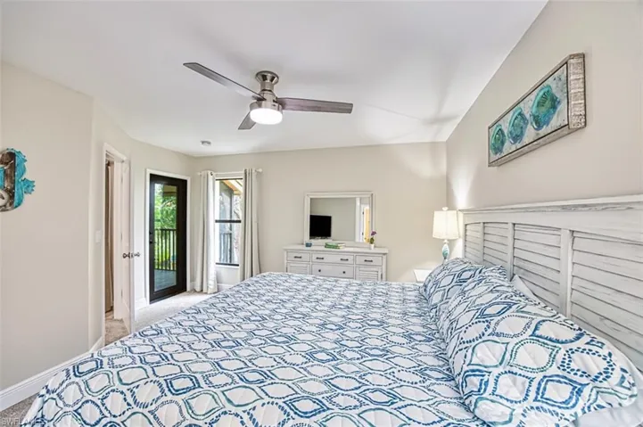 Bedroom featuring access to exterior, light carpet, ceiling fan, and baseboards