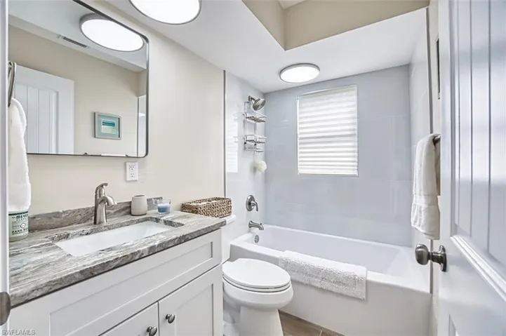 Full bathroom featuring toilet, vanity, and bathtub / shower combination