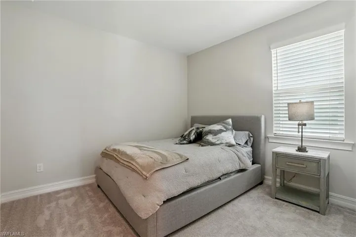 Bedroom with carpet flooring and baseboards