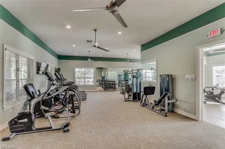 Exercise room with ceiling fan, carpet floors, and recessed lighting