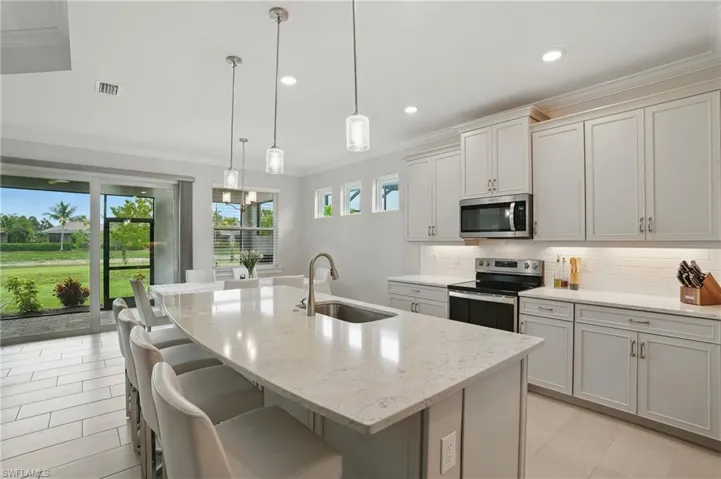 Dining space featuring a chandelier, crown molding, light tile patterned flooring, and recessed lighting