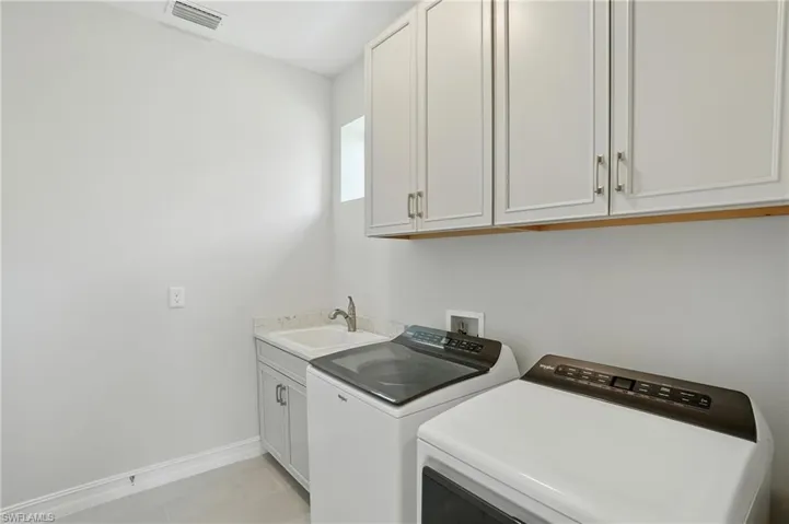 Laundry room featuring washer and dryer and cabinet space