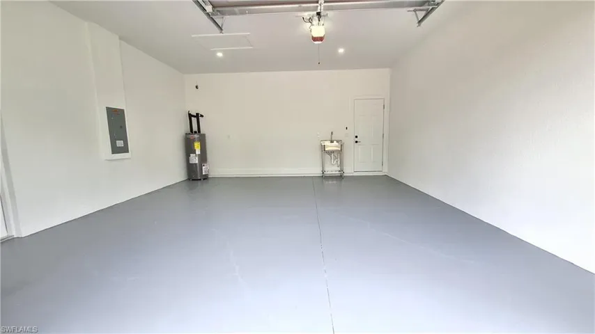 Garage with electric water heater and electric panel