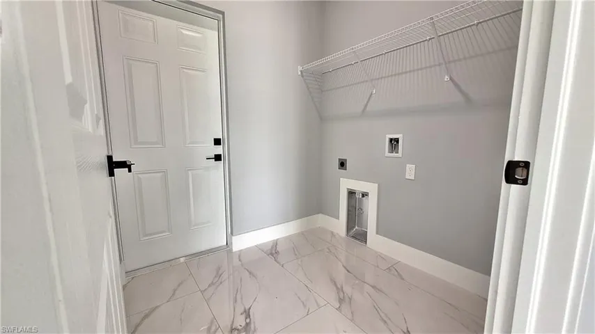 Laundry room featuring light marble finish flooring, washer hookup, and hookup for an electric dryer