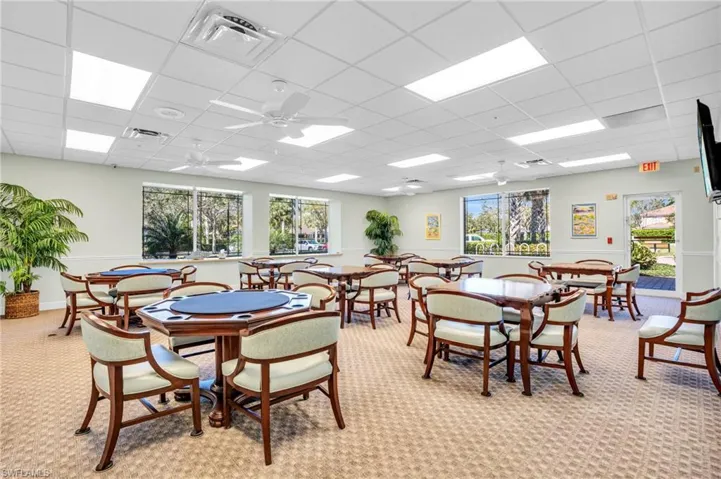 Dining room featuring ceiling fan, a drop ceiling, and visible vents