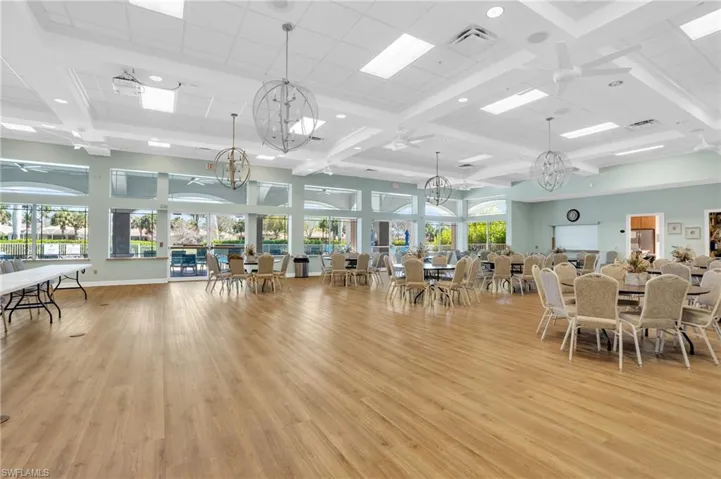 Dining space featuring a wealth of natural light, light wood-type flooring, visible vents, and an inviting chandelier