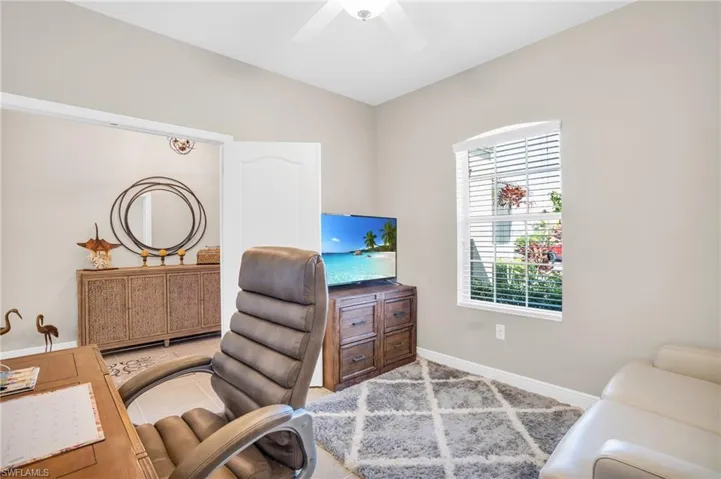 Office space featuring a ceiling fan and baseboards