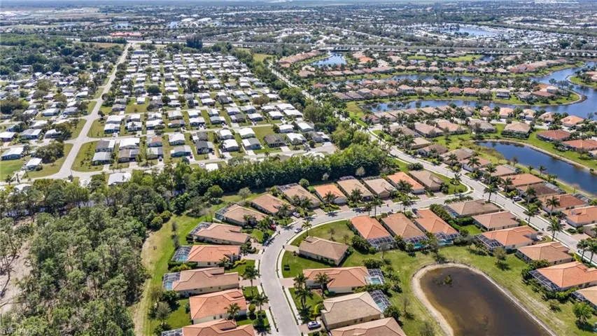 Birds eye view of property featuring a water view and a residential view