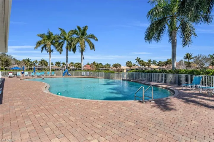 Pool with a patio and fence