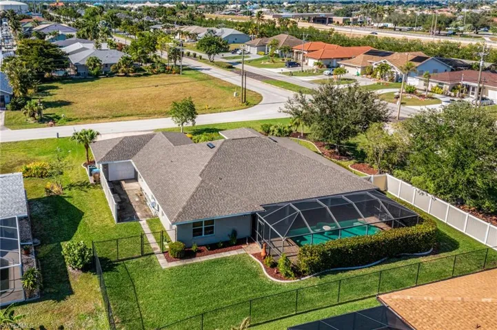 Aerial view of the Back... note paved drive at back of third Garge Bay, the Privacy Fence on both sides and lush landscaping between the house & street.