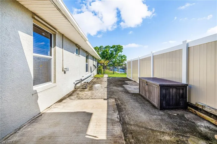 Paved Drive at Back Opening of Third Garage Bay with Privacy Fence