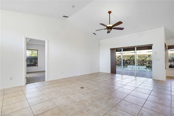 Great Room with Sliders to Lanai and Primary Suite at Left