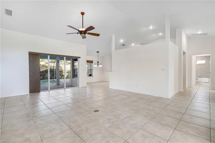 Great Room with Volume and Cathedral Ceiling sliders to Lanai