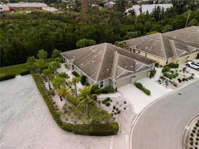 End unit attached villa with large side yard and preserve views.